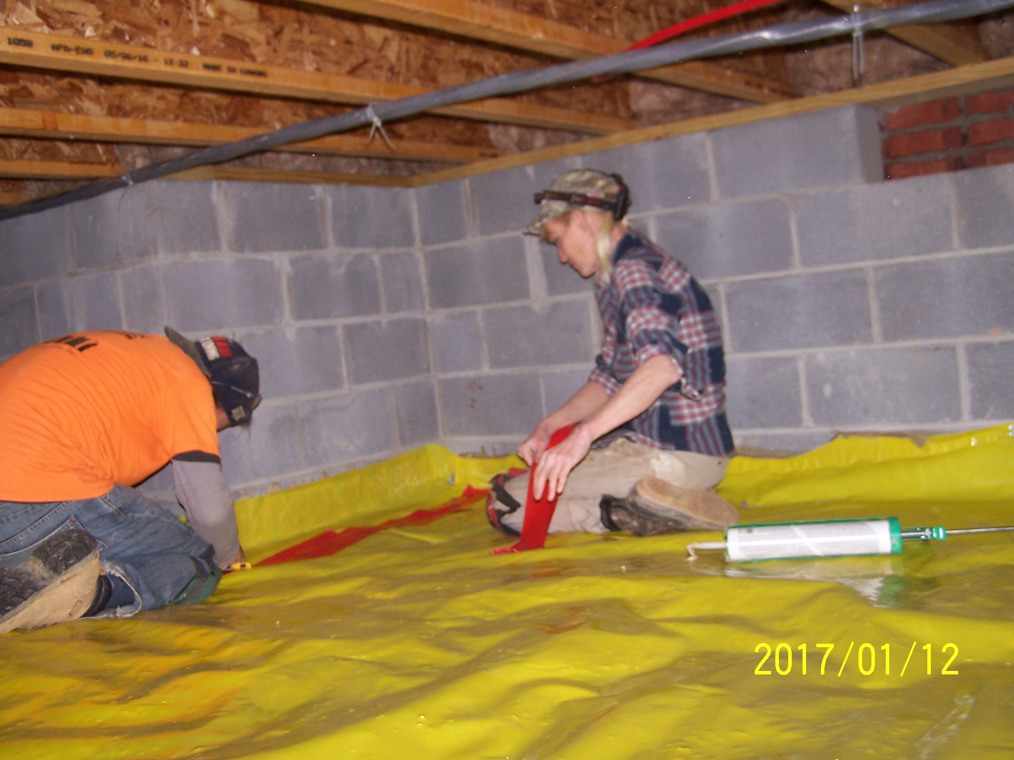 Installing the vapor barrier is one of the first steps for crawlspace encapsulation. installing-vapor-barrier-in-crawl-space